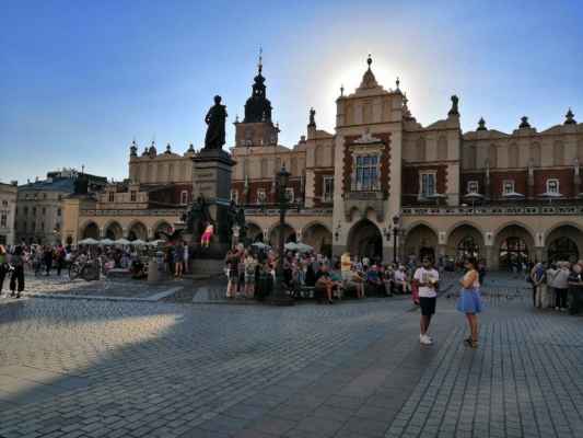 Polsko - město Krakow - Polsko - královské město Krakow - náměstí... v popředí je socha Adama Mickiewicze a v pozadí historická tržnice Sukiennice...